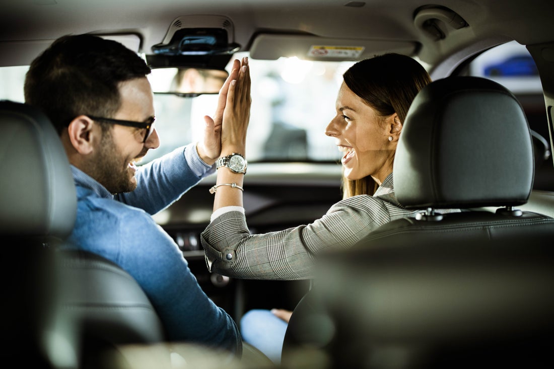 a man and a woman taking a selfie in a car